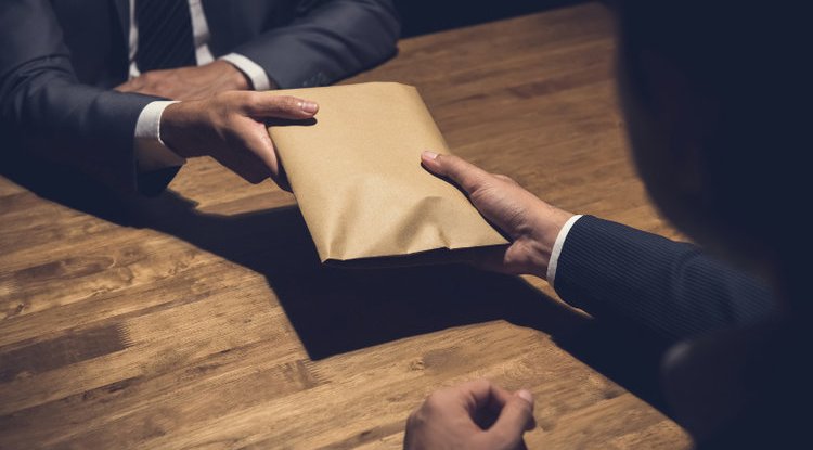 Police officers were detained after they allegedly insisted on paying R15,000 for the case docket.
