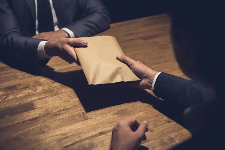 Police officers were detained after they allegedly insisted on paying R15,000 for the case docket.